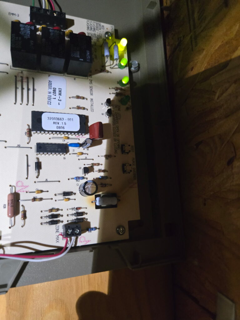 ACE Comfort technician fixing a zone control system in a Rice Military home, keeping the Oliver family cool and happy
